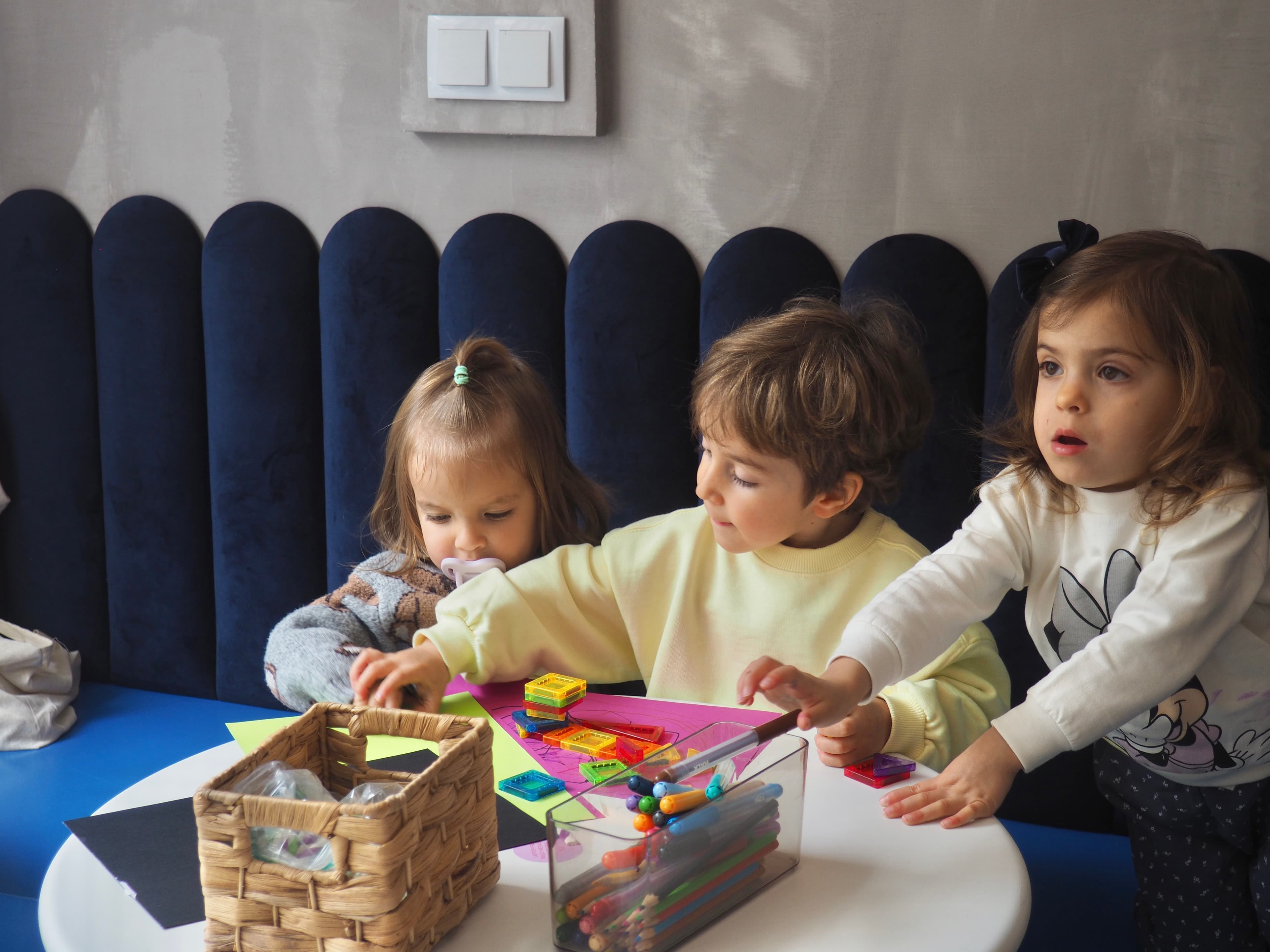 Parents and babies gathered for a Baby & Me session in a calm indoor space